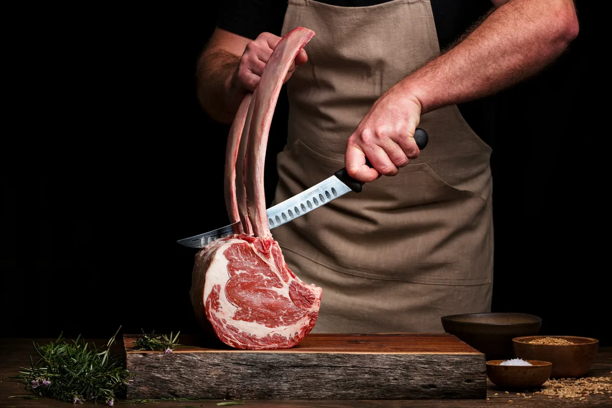 person holding red plastic shovel — professional food preparation environment